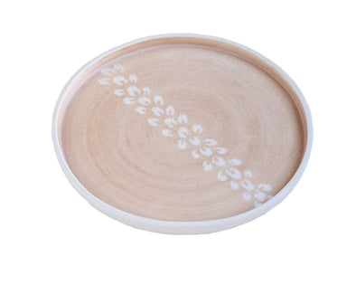 Assiette porcelaine rose sable motifs blancs